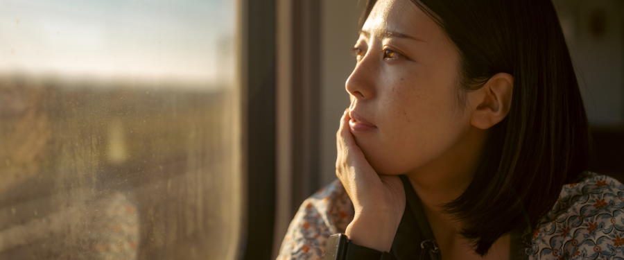 Young woman looking out of window. 