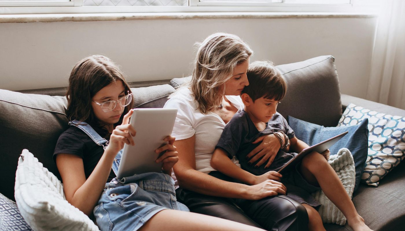 Woman sitting on the lounge with her two children