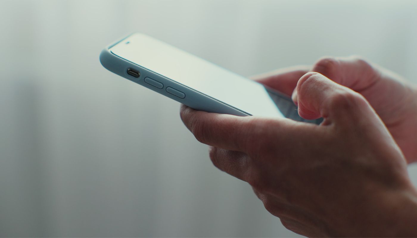 Person holding their mobile phone