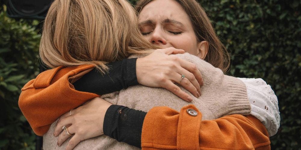 Two female friends embracing in a hug