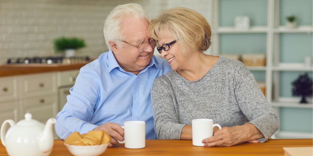 Older couple talking at kitchen bench