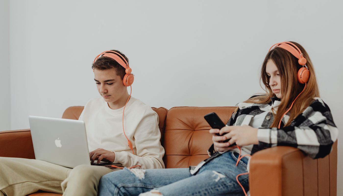 Two teenagers on their digital devices