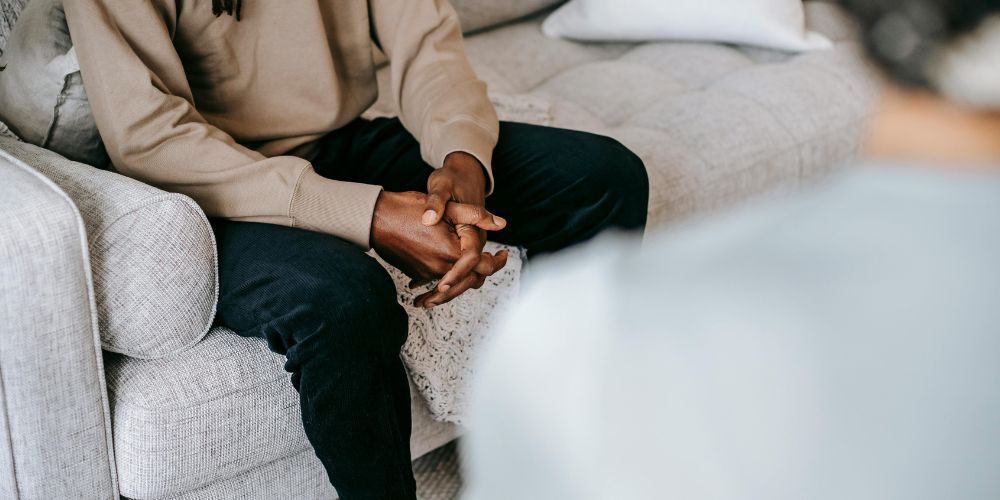 Young man sitting in therapy room