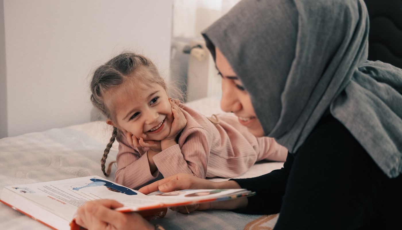 Mother reading with her young daughter
