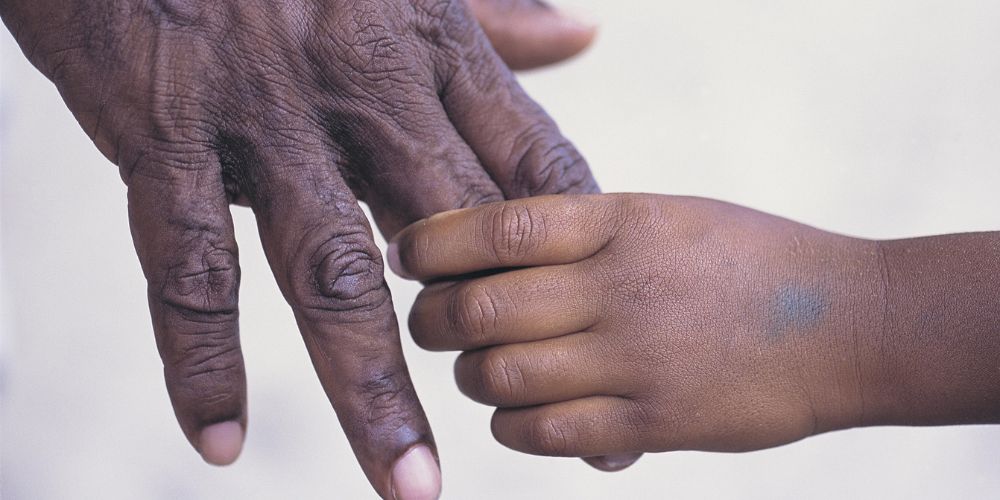 Two indigenous Australian's holding hands
