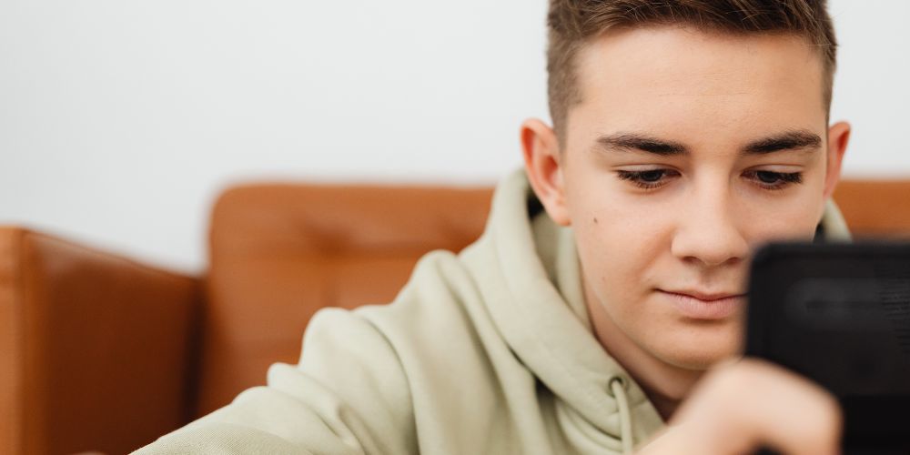 Teen boy on his mobile phone