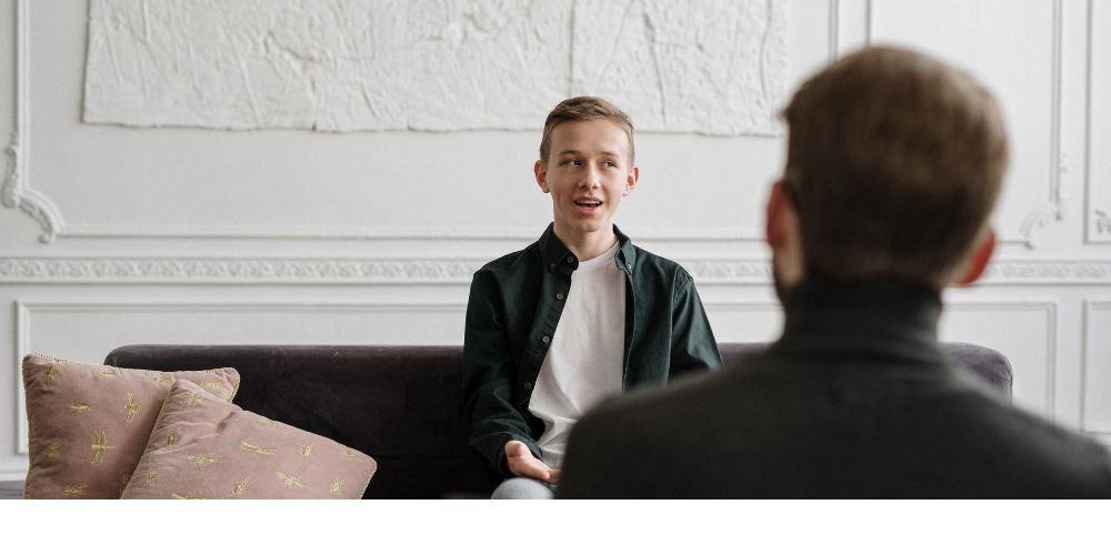 A young person talking to and older person