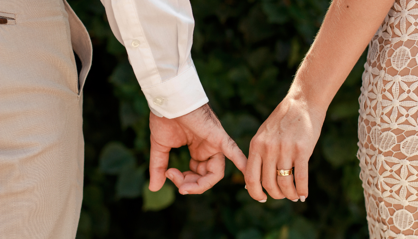 A closeup of a couple holding hands