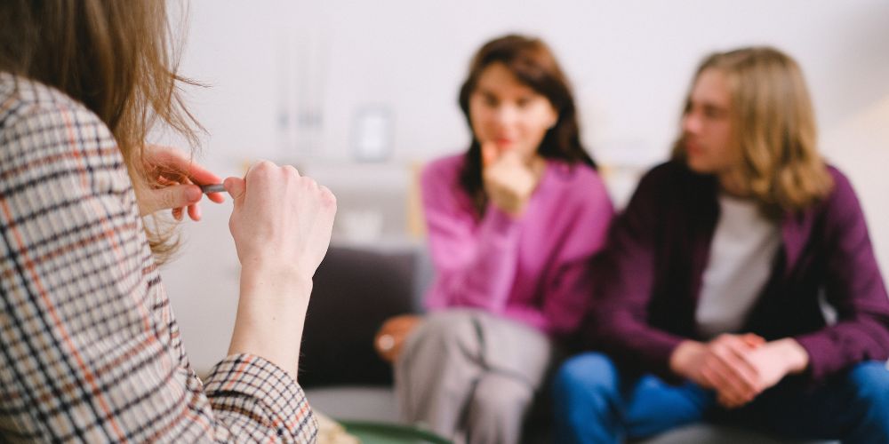 Psychologist talking to two clients