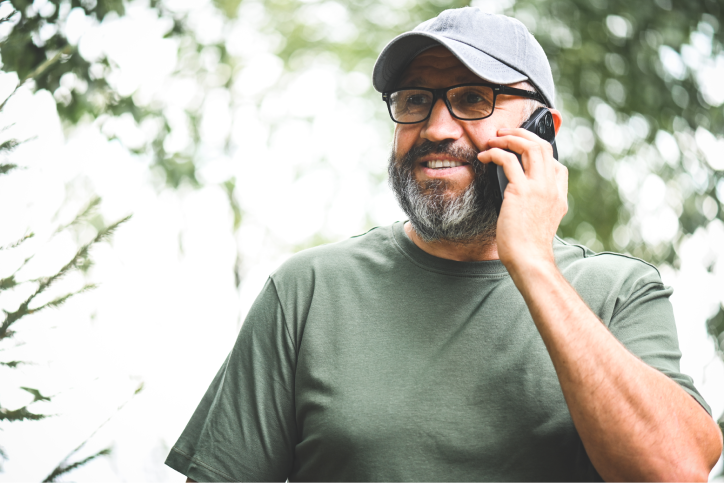 Disaster volunteer picking up the phone while in nature. 