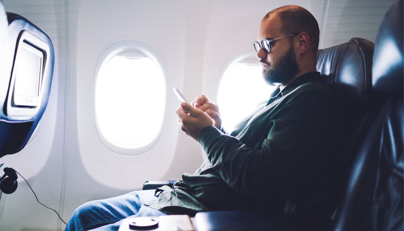Male passenger sitting on plane.