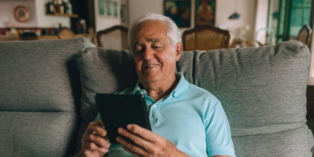 Elderly man using his tablet