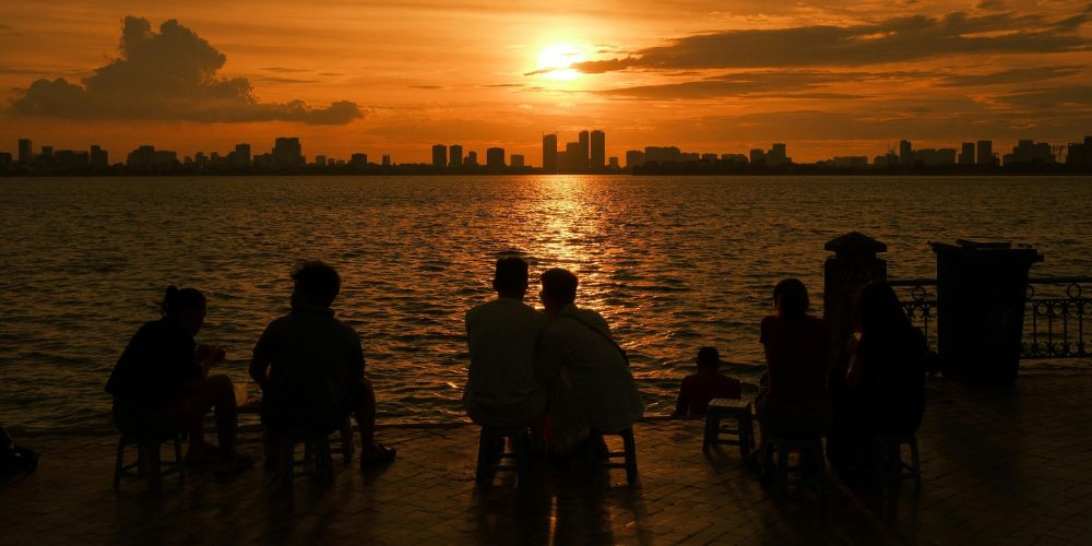 Group of people gathered watching sunset