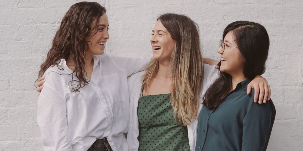 Three female friends laughing