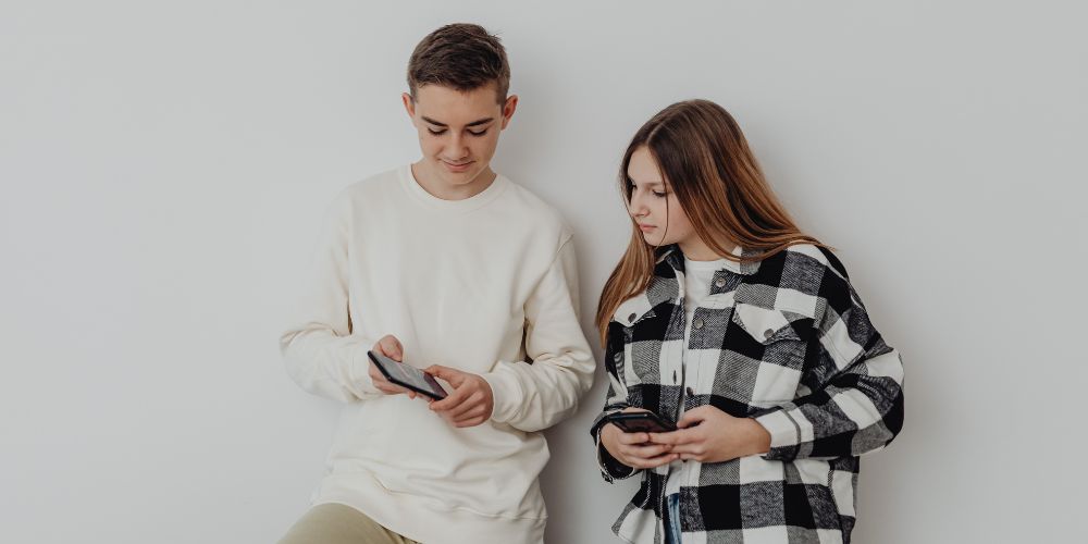 Two teens on their devices