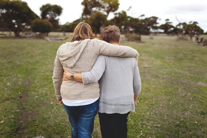 Younger woman arm in arm with older woman