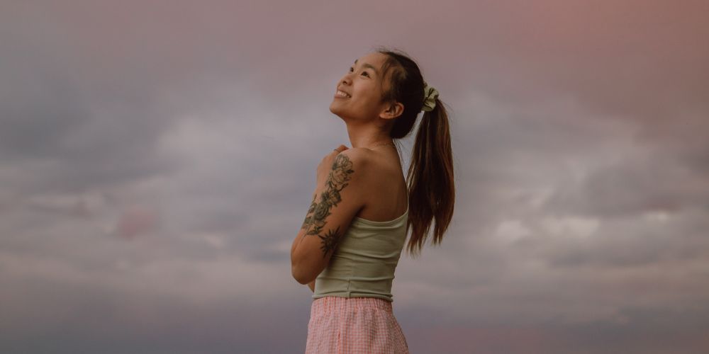 Young woman looking up into sky
