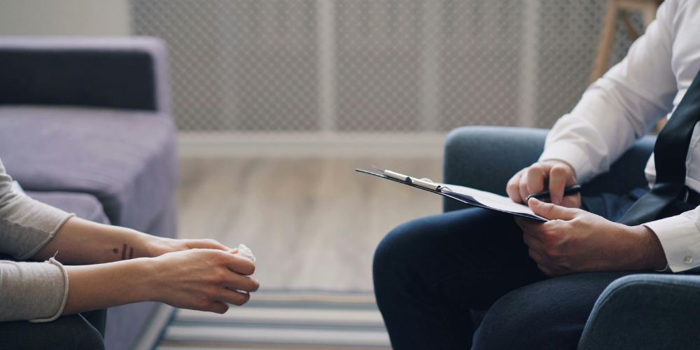 Person sitting in therapy talking to psychologist