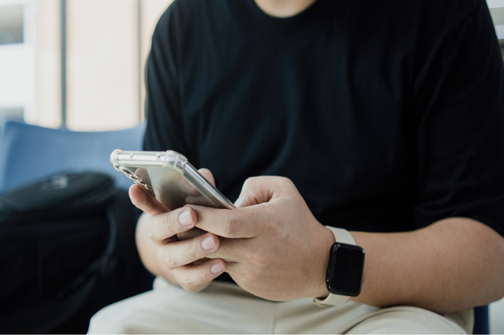 Man holds his mobile phone in his hands.