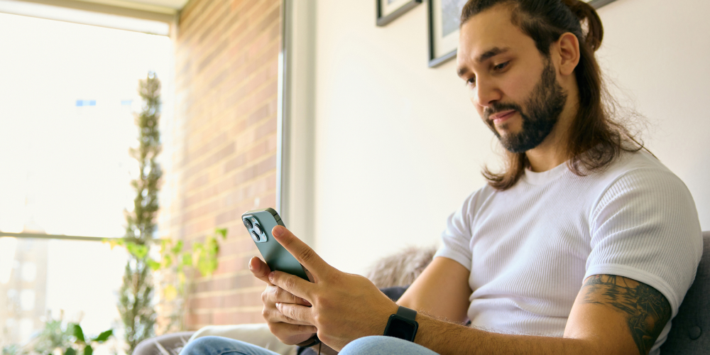 Man-looking-at-phone-using-AI-for-mental-health-support