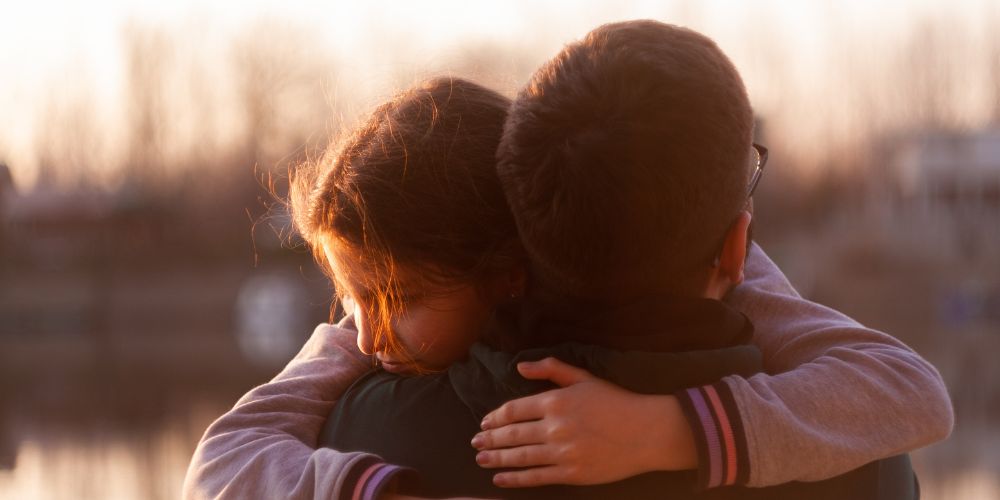 Father comforts his daughter with a hug