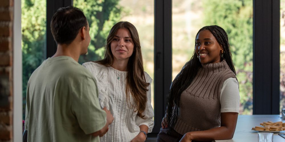 Three friends standing around talking