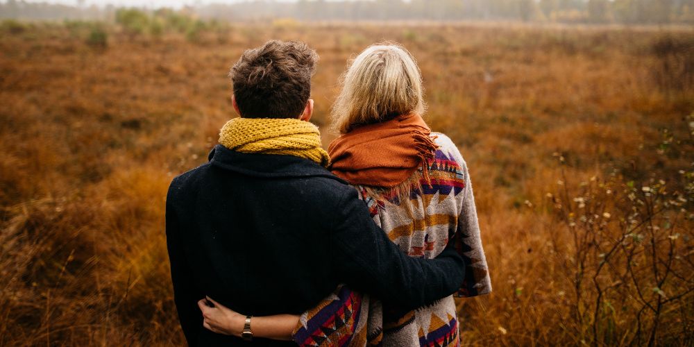 Couple hugging looking into distance