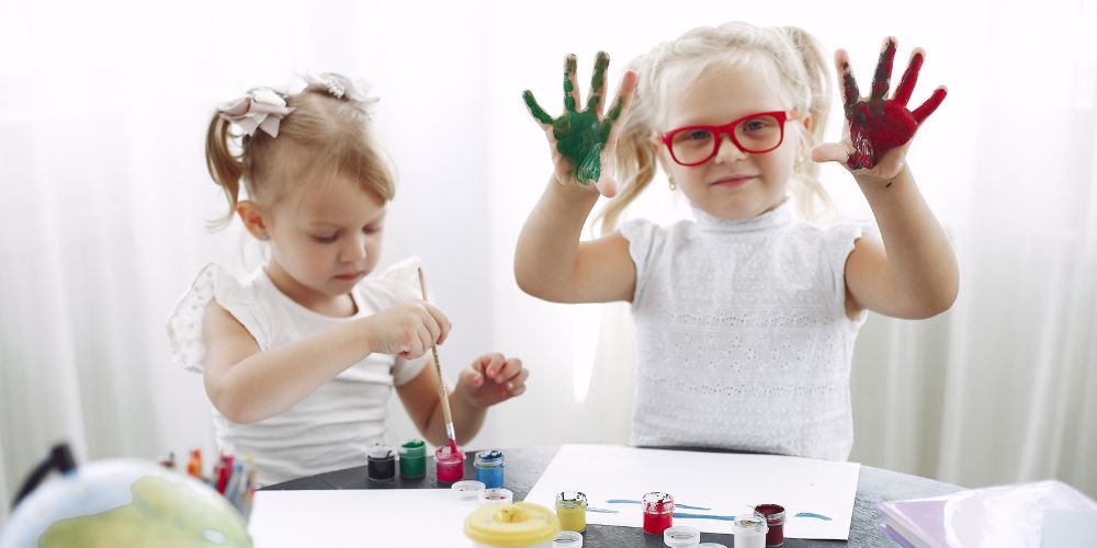 Two young children painting