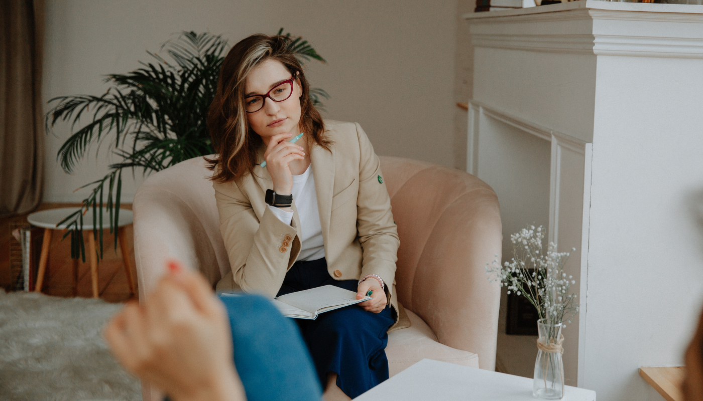 Psychologist sitting talking to her client.