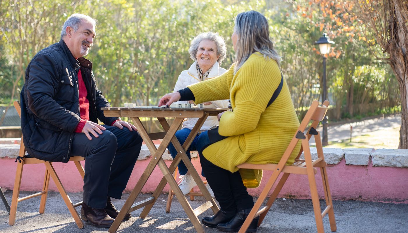 Elderly friends play mahjong in park