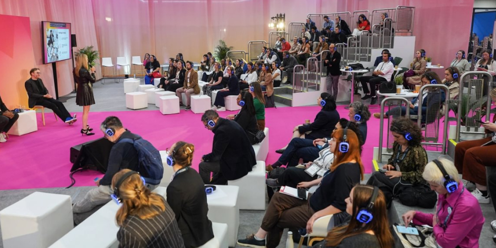 People at a presentation, the attendees are wearing noise cancelling headphones