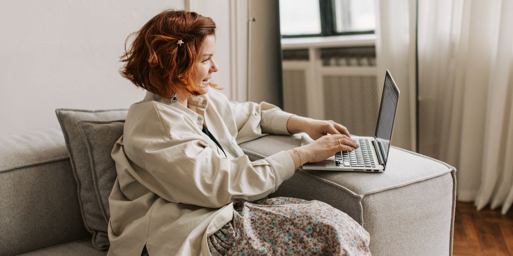 Woman using laptop on sofa