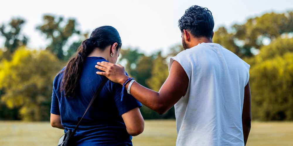 Male friend comforting woman