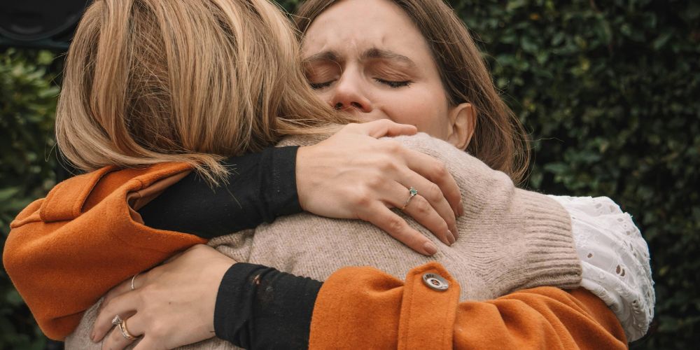 two women embracing in hug