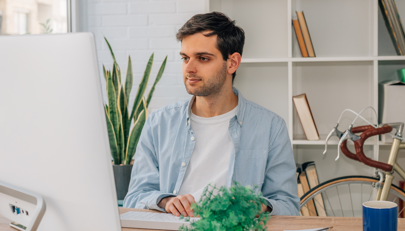 Man sitting at desk working on his computer.