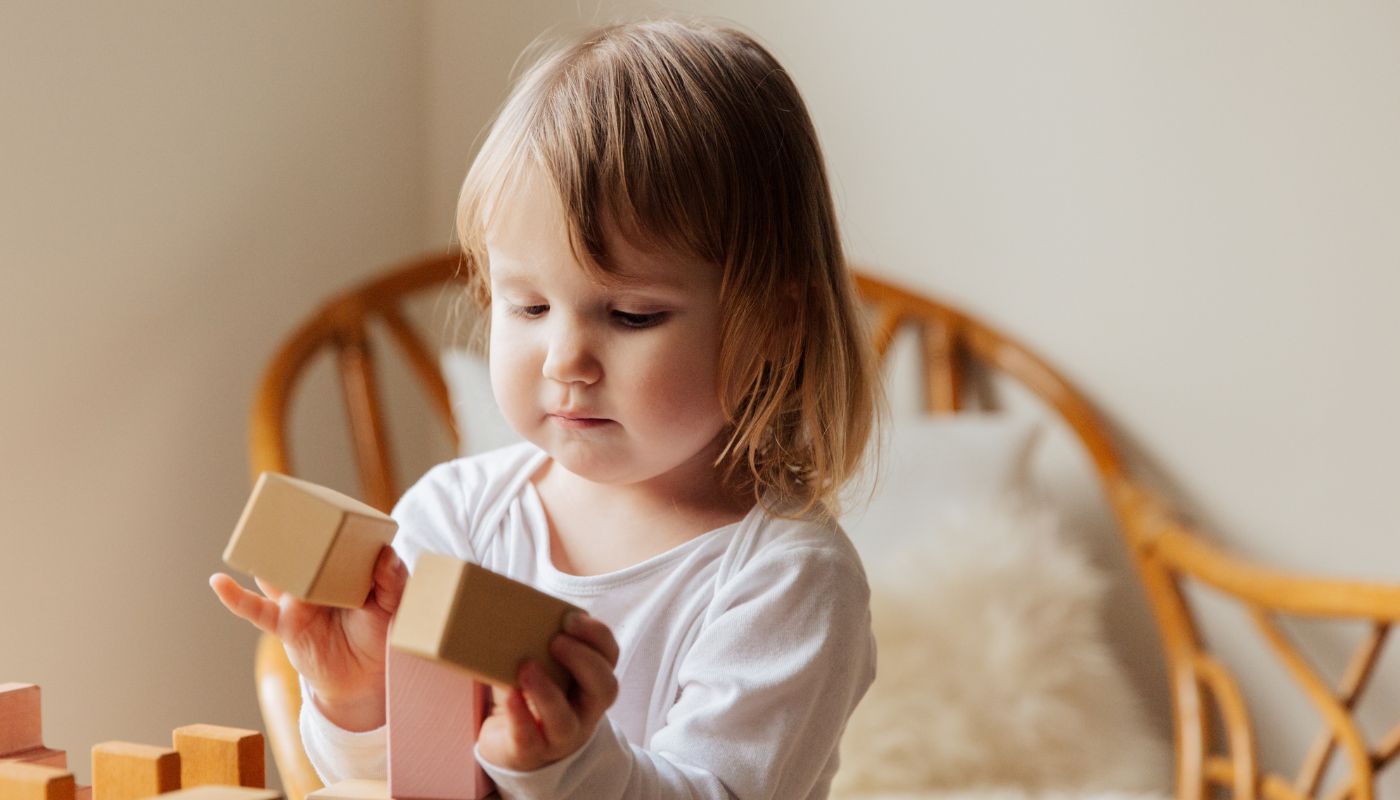 Young child plays with building blocks.