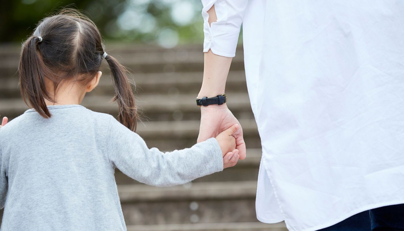 Mother walking with her child.